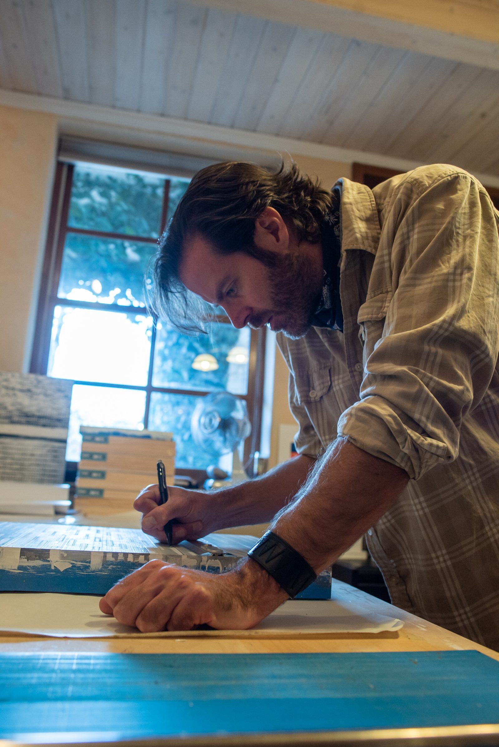 John Vokoun signing a finished panel in the studio